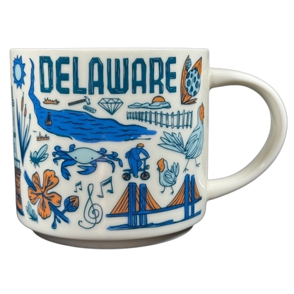 Starbucks Delaware Been There mug featuring blue and orange Delaware icons and landmarks on white ceramic