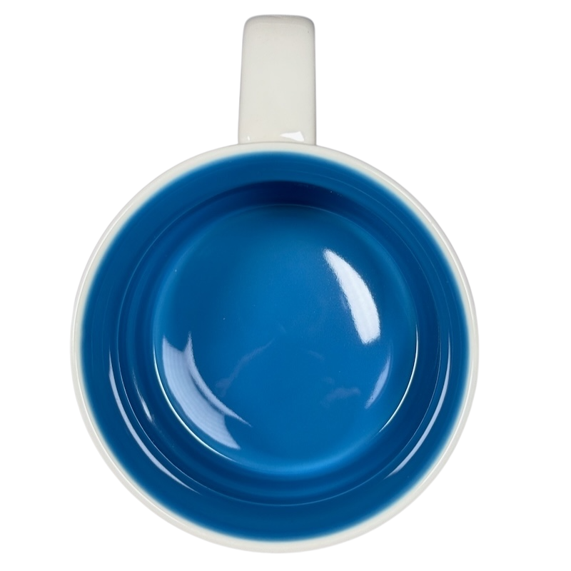 Top view of Starbucks Delaware Been There mug with blue interior and white handle on black background