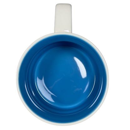 Top view of Starbucks Delaware Been There mug with blue interior and white handle on black background