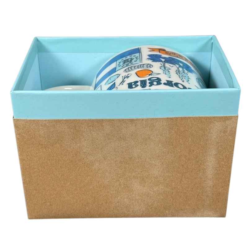 Starbucks Georgia Been There Series mug partially visible inside blue and brown gift box