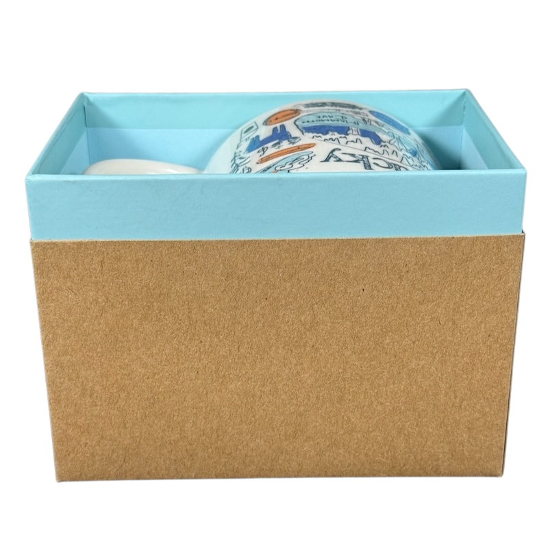 Kentucky Starbucks Been There mug partially visible inside a blue and brown gift box on black background