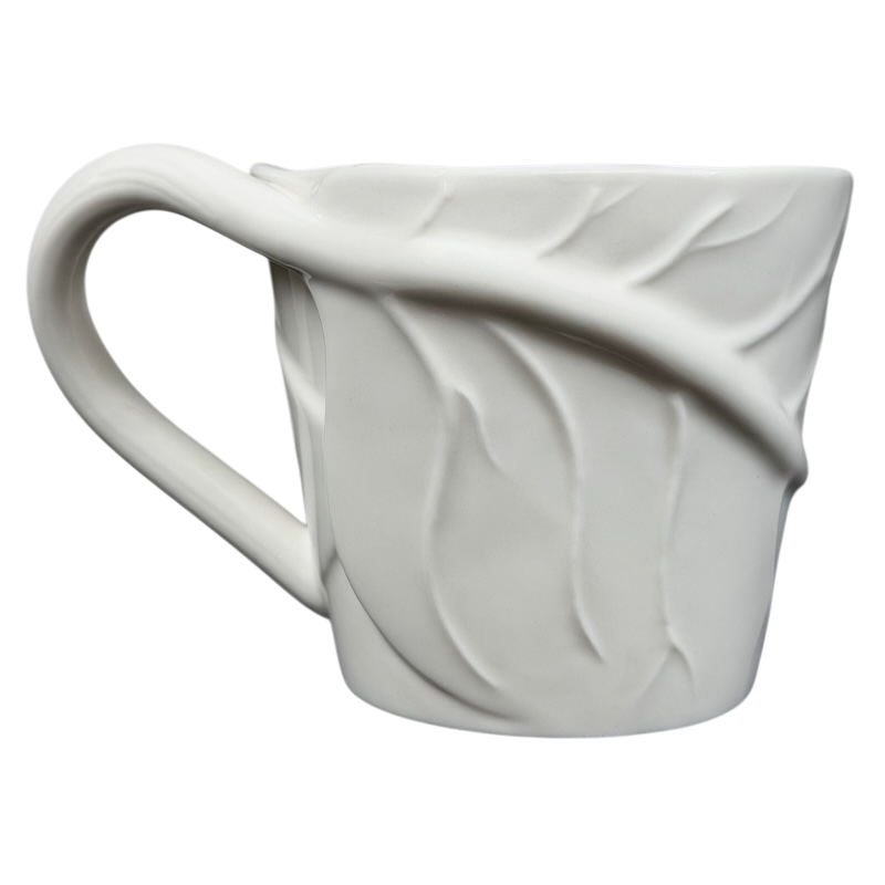 Starbucks leaf mug featuring an elegant leaf design on a textured white ceramic surface