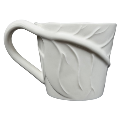 Starbucks leaf mug featuring an elegant leaf design on a textured white ceramic surface