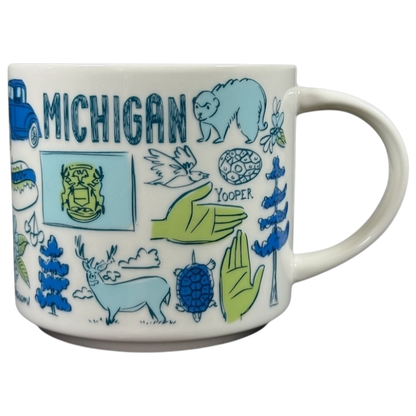 Starbucks Michigan Been There mug featuring hand-drawn state icons and symbols in blue and green