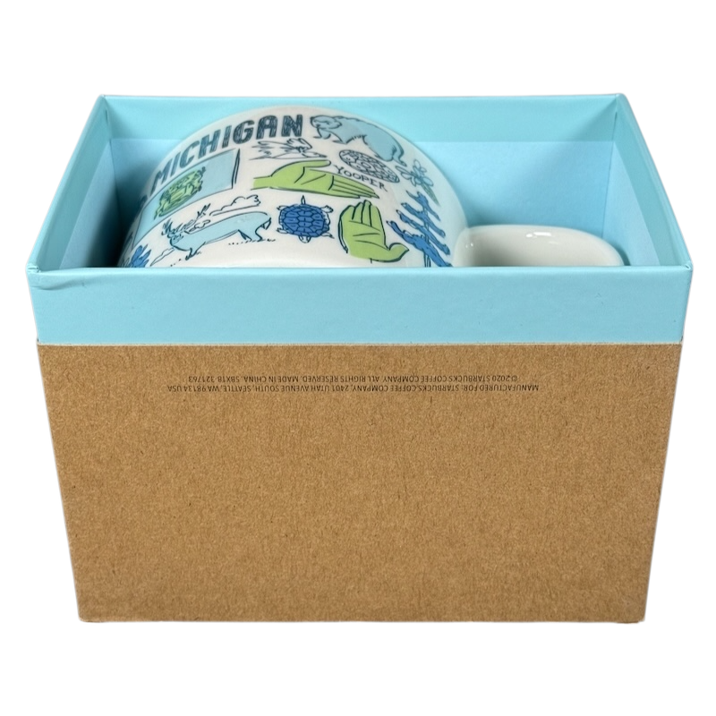 Starbucks Michigan Been There mug featuring state-themed illustrations in a blue and brown gift box