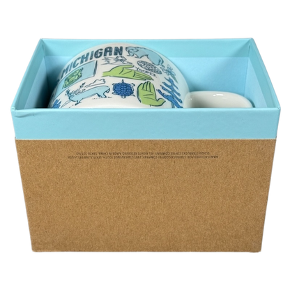 Starbucks Michigan Been There mug featuring state-themed illustrations in a blue and brown gift box