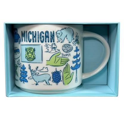 Starbucks Michigan Been There mug featuring state-themed illustrations in blue and green in a light blue box