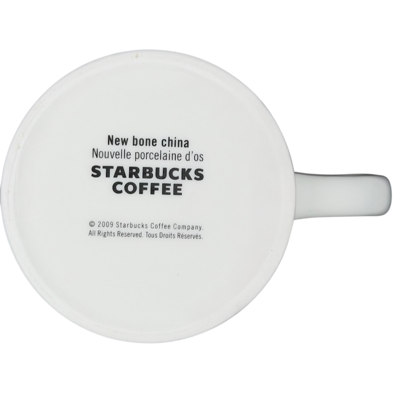 Bottom view of a white Starbucks coffee cup labeled New Bone China Brown Interior 2009 Starbucks