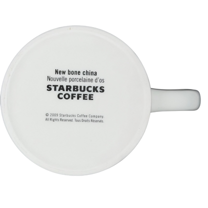 Bottom view of a white Starbucks coffee cup labeled New Bone China Brown Interior 2009 Starbucks