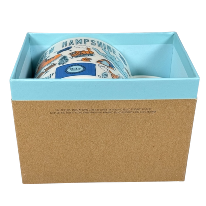 Starbucks New Hampshire Been There mug partially inside light blue and brown gift box