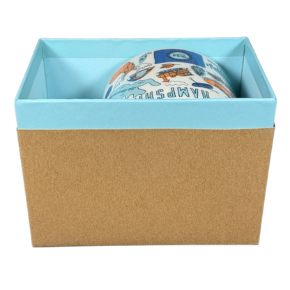 Starbucks New Hampshire Been There mug partially visible inside a blue and brown gift box