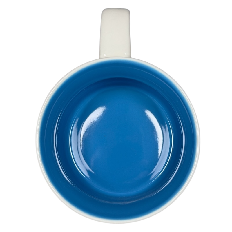 Top view of Starbucks New Hampshire Been There mug with blue interior and white handle on black background
