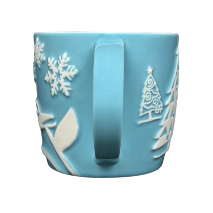Starbucks penguin snowman skiing vintage mug in light blue with embossed winter designs