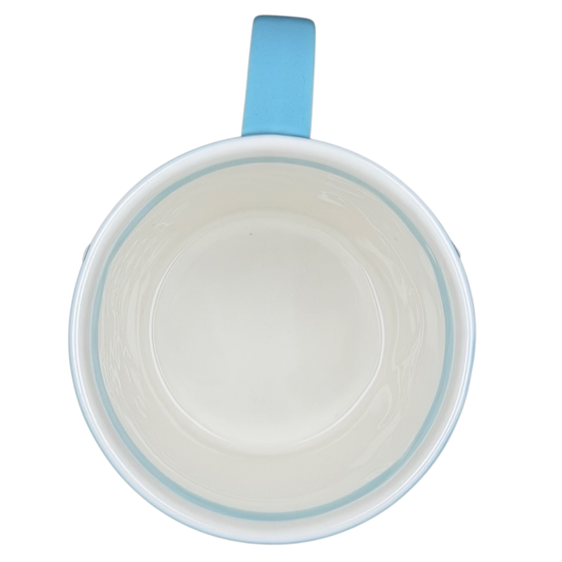 Inside view of a vintage cup featuring a blue handle, perfect for the Starbucks penguin snowman skiing vintage mug