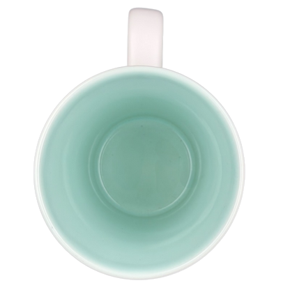 Inside view of a rare Starbucks XOXO mug featuring a mint green finish and a white handle
