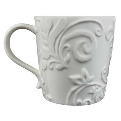Elegant white Reindeer Mug Starbucks with embossed floral design for hot beverages
