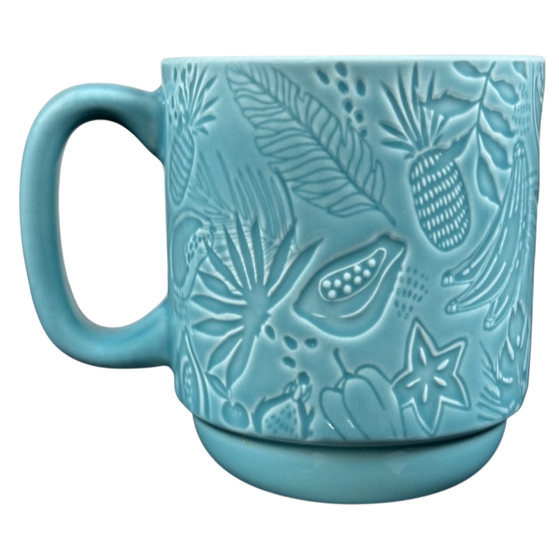 Teal embossed ceramic mug with tropical fruit and leaves pattern and handle Starbucks Hawaii siren mug collectible