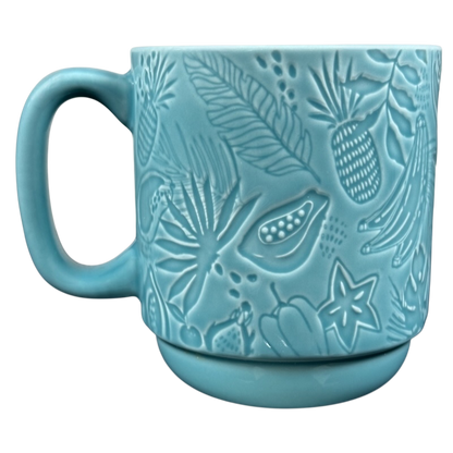 Teal embossed ceramic mug with tropical fruit and leaves pattern and handle Starbucks Hawaii siren mug collectible