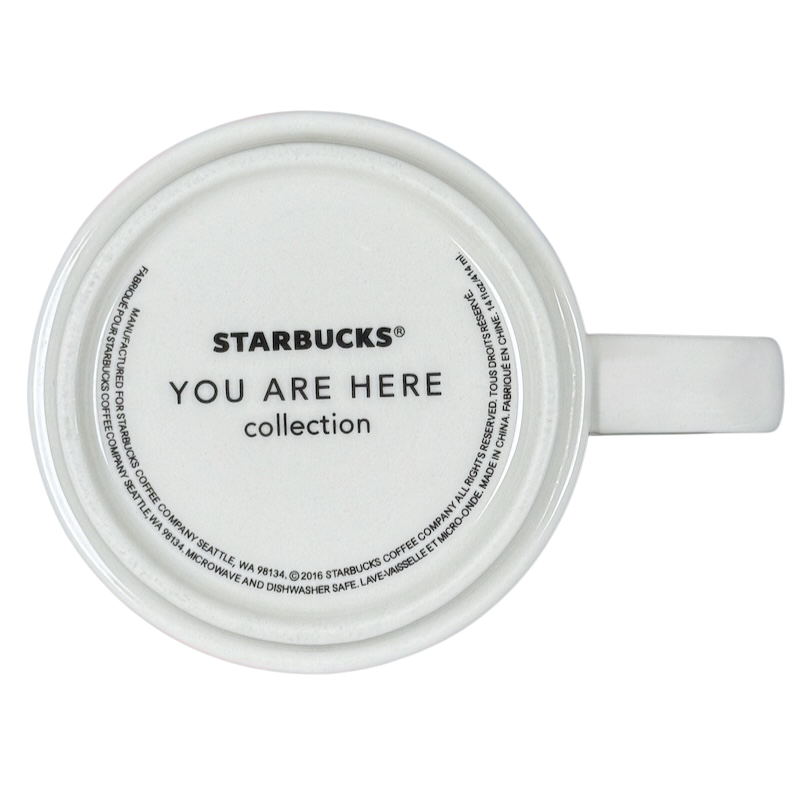 Top view of white Starbucks New Jersey You Are Here collectible mug. Shows bottom logo and handle on black background