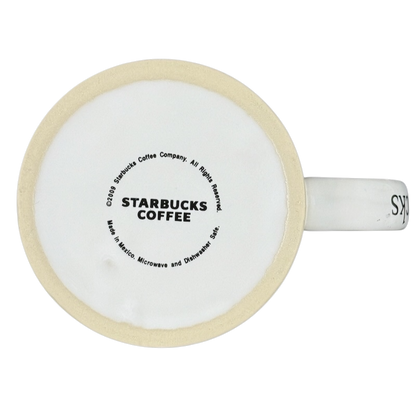 Bottom view of a white ceramic Starbucks Puerto Vallarta vintage mug showing Starbucks Coffee stamp Made in Mexico and beige rim