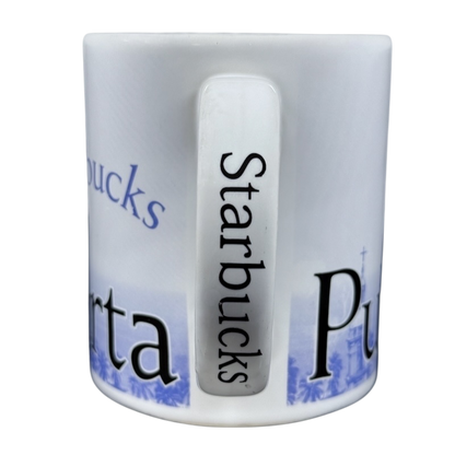 White Starbucks Puerto Vallarta vintage mug showing handle with vertical Starbucks logo and blue coastal design