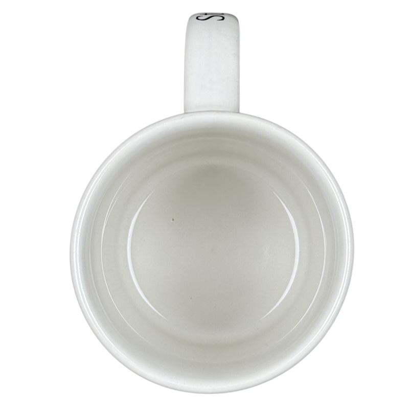 Top view of empty white ceramic Starbucks Puerto Vallarta vintage mug with handle on black background