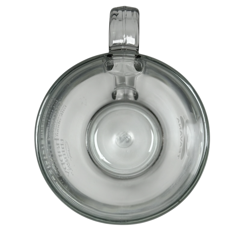 Top view of clear Starbucks Teavana Come Let Us Have Some Tea glass mug with handle on black background