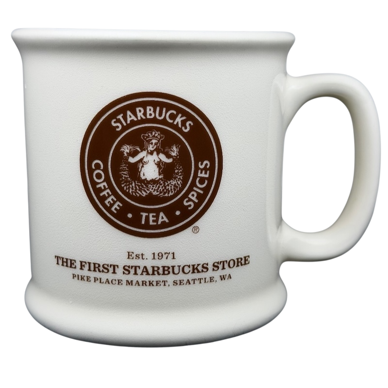 Ceramic white mug featuring The First Starbucks Store Pike Place Market Seattle WA logo with handle