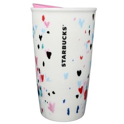 Starbucks Valentine's Day embossed heart tumbler in white with colorful heart designs and pink lid