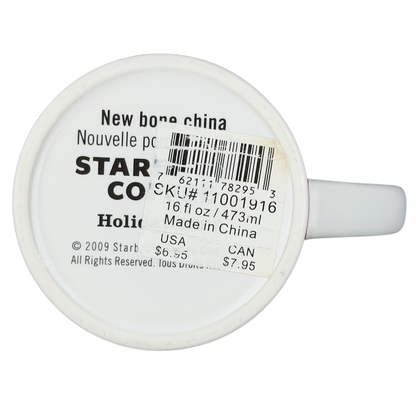 Vintage 2009 Starbucks holiday mug with a white exterior and 16 oz capacity, made in China