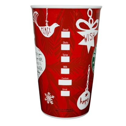Vintage 2009 Starbucks holiday mug with festive red design featuring wish and peace symbols