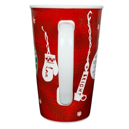 Vintage 2009 Starbucks holiday mug in red with festive designs and a white handle