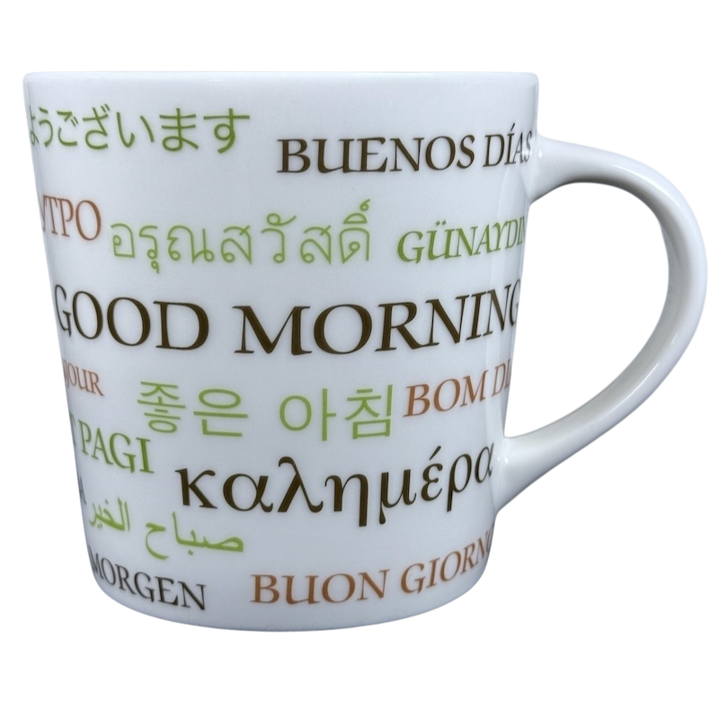 White ceramic vintage Starbucks Good Morning mug. Multilingual Good Morning text printed in green and brown