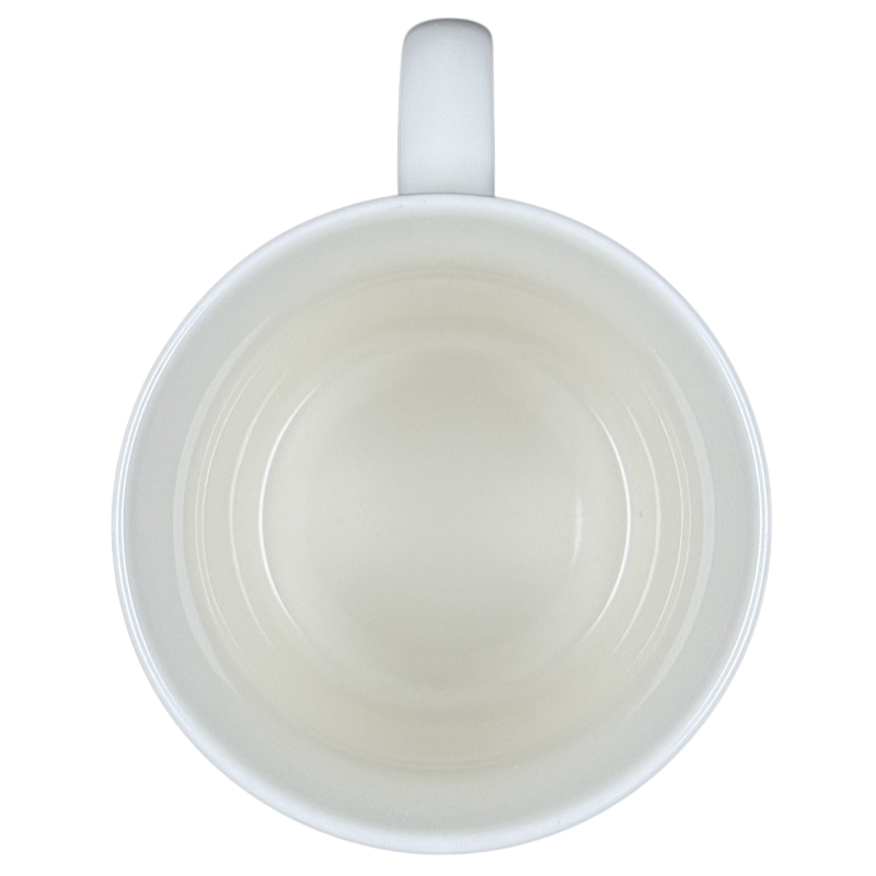 Top view of empty white ceramic vintage Starbucks Good Morning mug showing handle and interior concentric rings