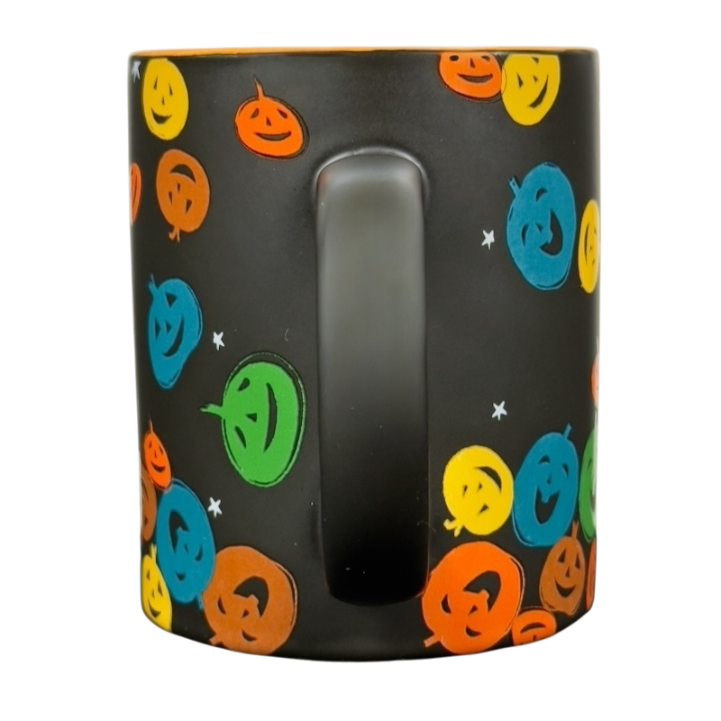 Black matte vintage Starbucks Halloween pumpkin mug with colorful smiling jack o lantern pattern and center handle