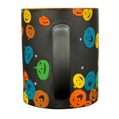 Black matte vintage Starbucks Halloween pumpkin mug with colorful smiling jack o lantern pattern and center handle