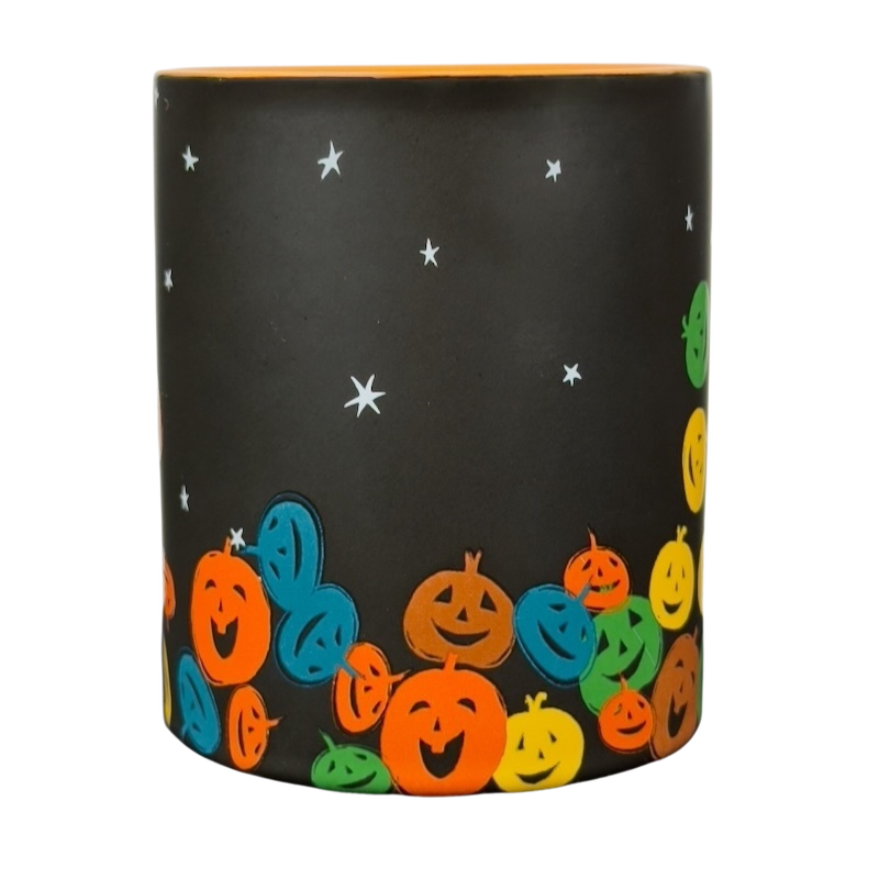vintage Starbucks Halloween pumpkin mug black matte cup with orange interior and colorful smiling jack o lanterns