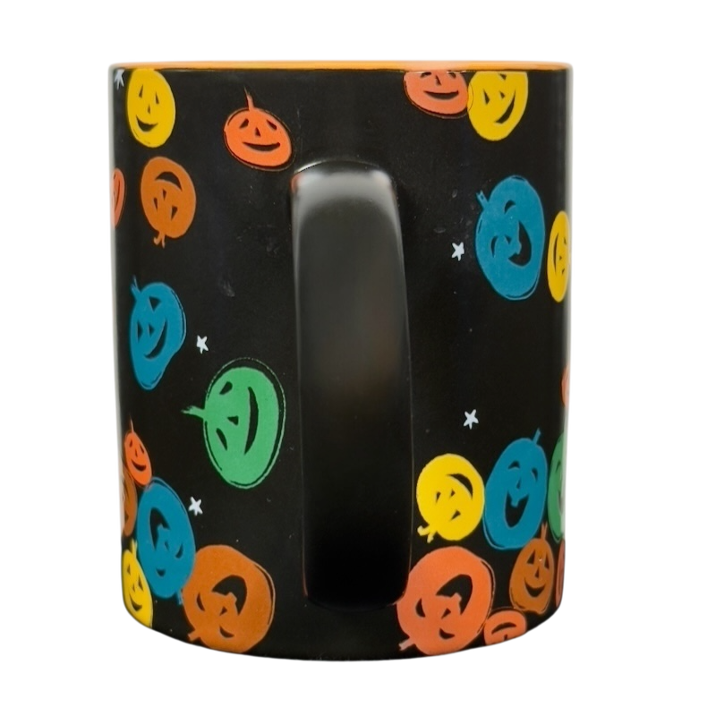 vintage Starbucks Halloween pumpkin mug black ceramic with colorful smiling jack o lantern faces and orange interior
