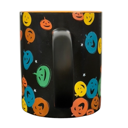 vintage Starbucks Halloween pumpkin mug black ceramic with colorful smiling jack o lantern faces and orange interior