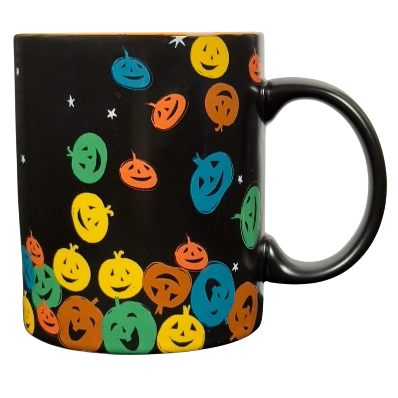 vintage Starbucks Halloween pumpkin mug black ceramic covered in colorful smiling jack o lantern faces and white stars