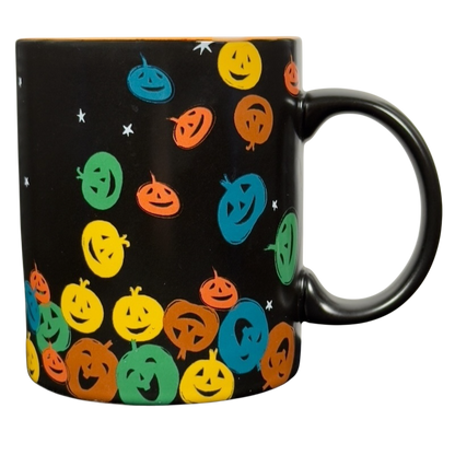 vintage Starbucks Halloween pumpkin mug black ceramic covered in colorful smiling jack o lantern faces and white stars