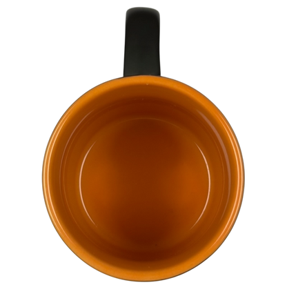 Top view of vintage Starbucks Halloween pumpkin mug orange glazed interior with black handle empty ceramic cup