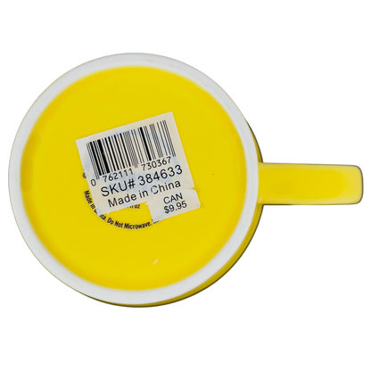 Bottom view of vintage Starbucks yellow sand pail mug showing SKU label and handle