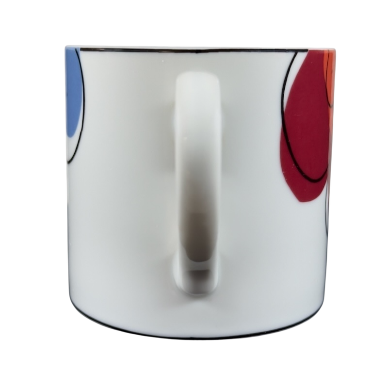 Swid Powell collectible mug featuring a modern design with colorful patterns and a sleek handle