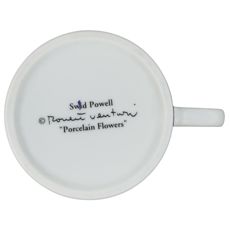 Bottom view of a Swid Powell collectible mug featuring a signature and Porcelain Flowers design