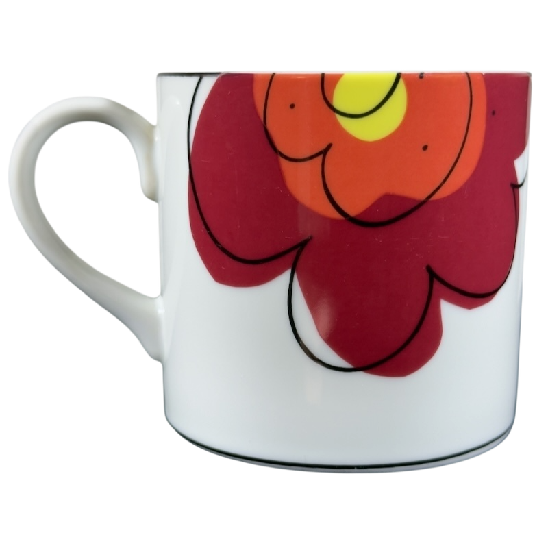 Swid Powell collectible mug featuring vibrant floral design with bold colors and sleek shape