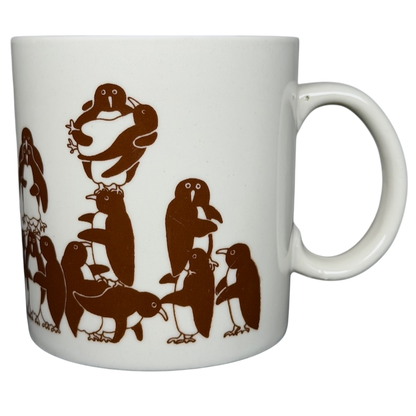 Taylor & Ng Animates vintage brown penguins mug featuring playful penguins in a fun design