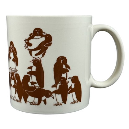 Taylor & Ng Animates vintage brown penguins mug featuring playful penguin designs in brown