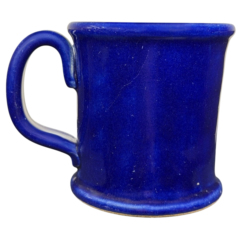 The Broadmoor Colorado Pottery Mug in a vibrant blue color with a sturdy handle