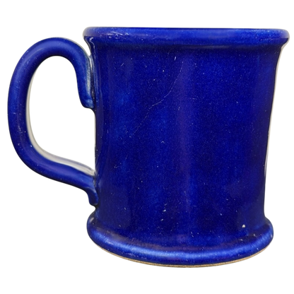The Broadmoor Colorado Pottery Mug in a vibrant blue color with a sturdy handle